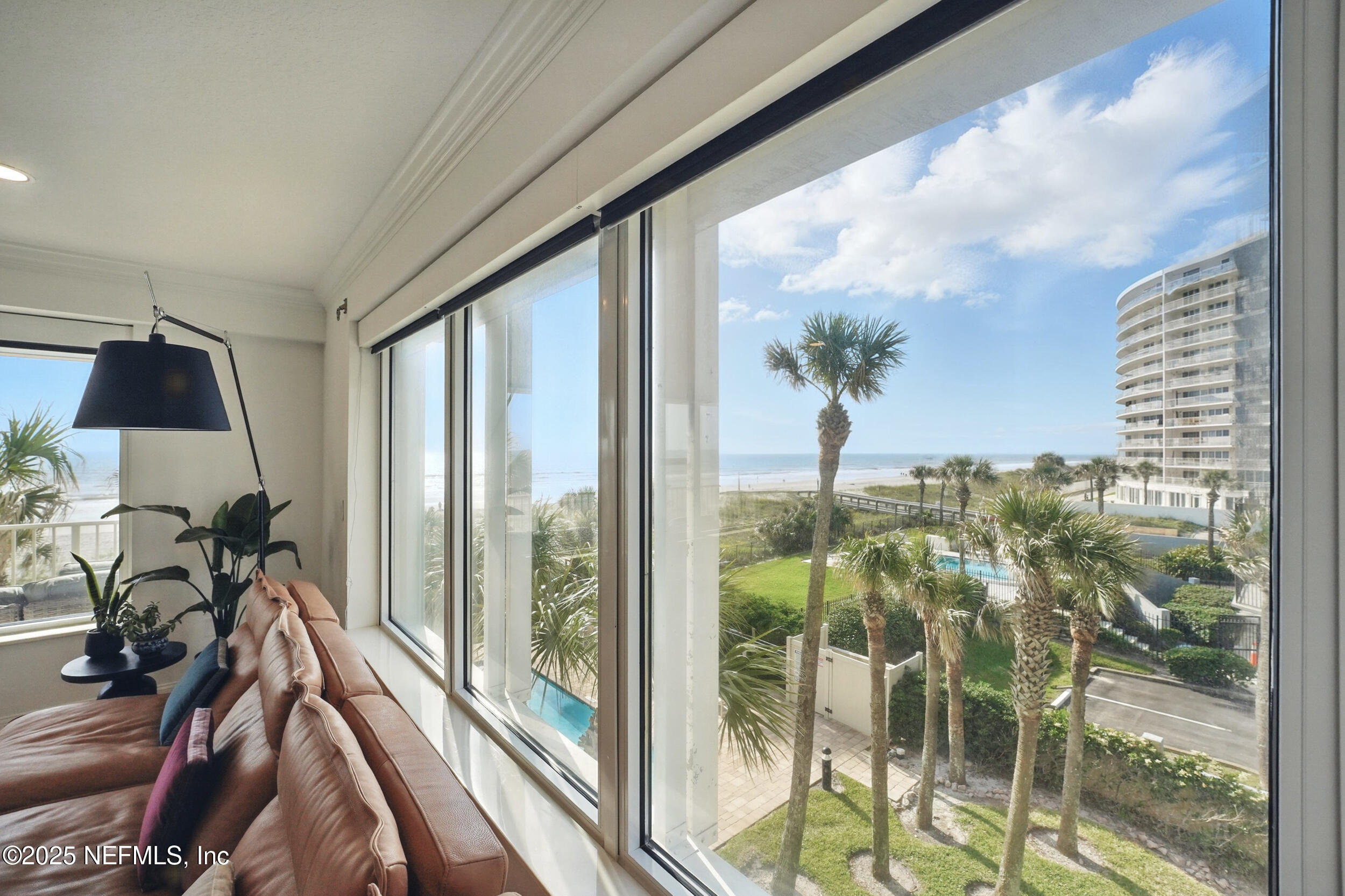 1505 1st Street South, Unit 302 Jacksonville Beach, FL 32250 - Photo 22 of 57 a view of a balcony with chair and glass door