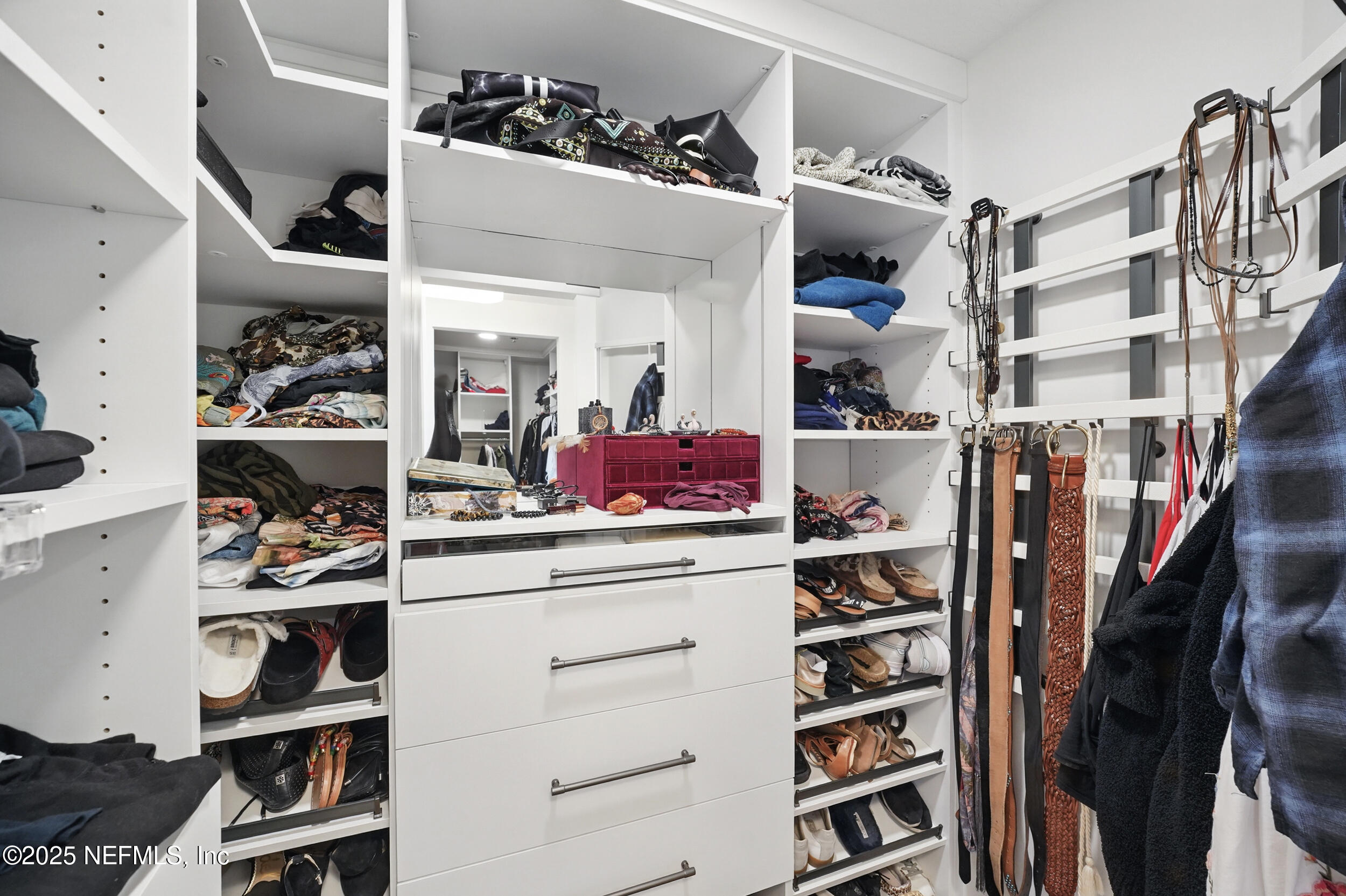 1505 1st Street South, Unit 302 Jacksonville Beach, FL 32250 - Photo 34 of 57 a view of walk in closet with clothes and shoes