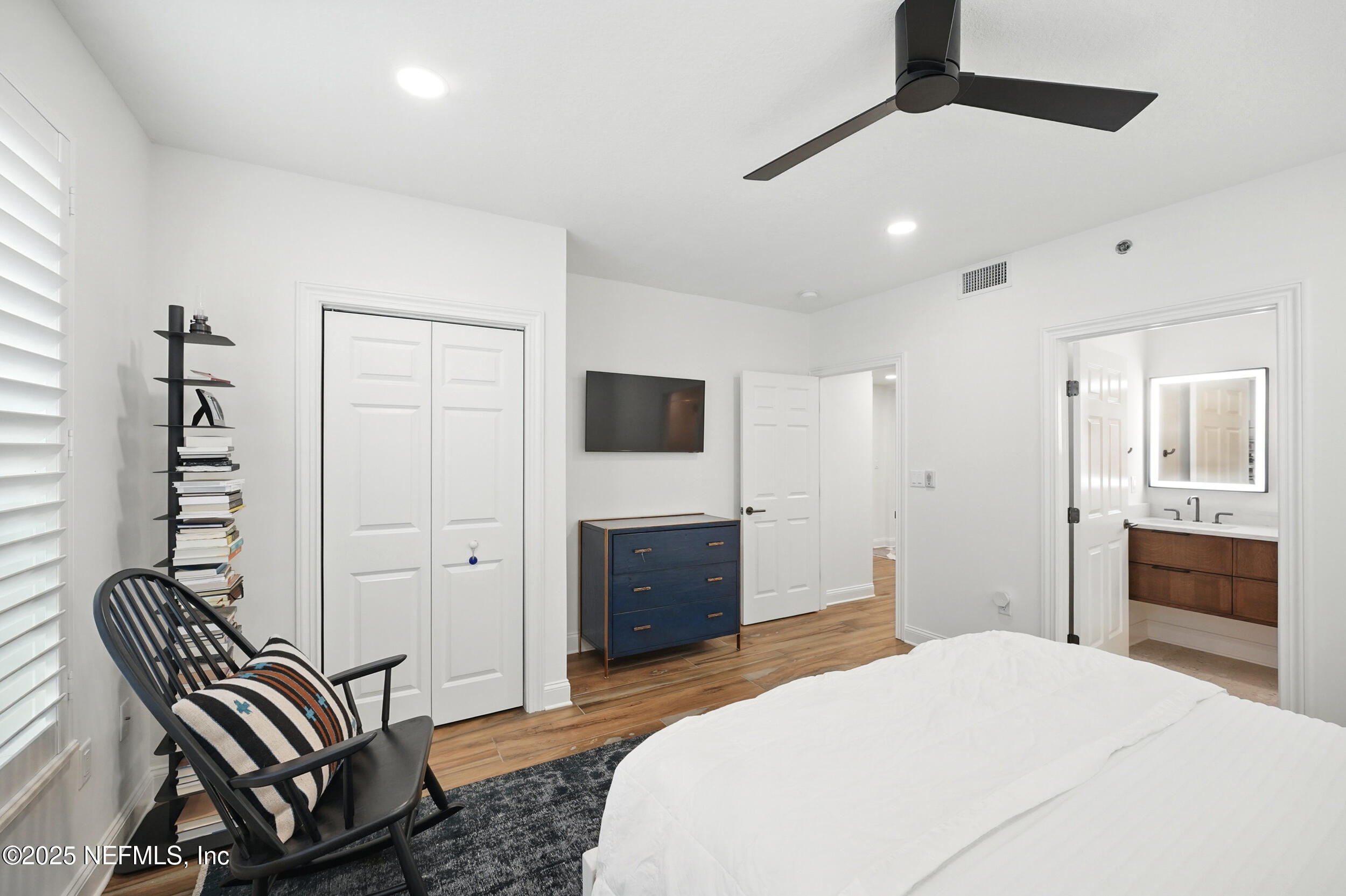 1505 1st Street South, Unit 302 Jacksonville Beach, FL 32250 - Photo 36 of 57 a bedroom with a bed and a flat screen tv