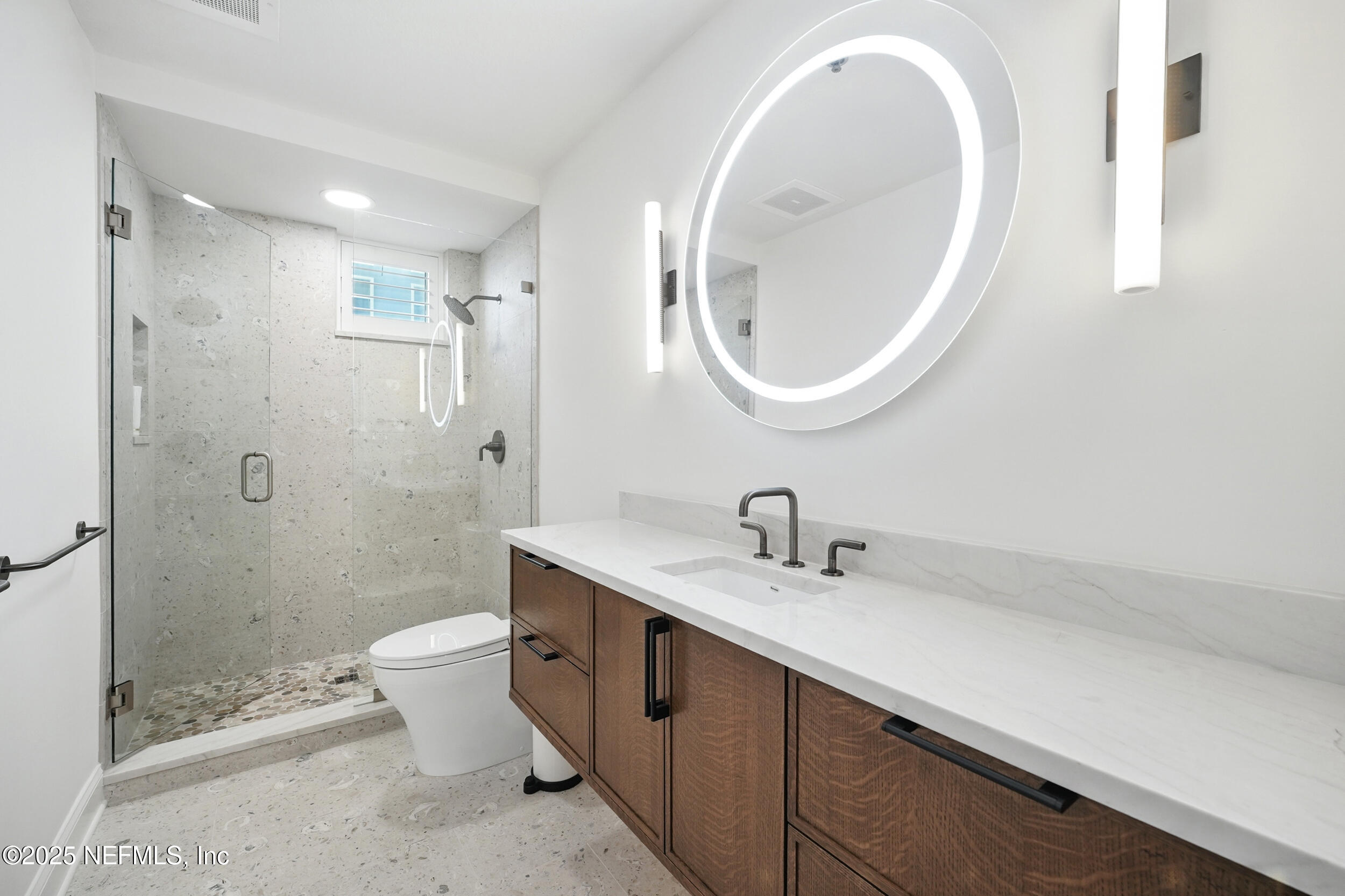 1505 1st Street South, Unit 302 Jacksonville Beach, FL 32250 - Photo 37 of 57 a bathroom with a double vanity sink toilet and shower