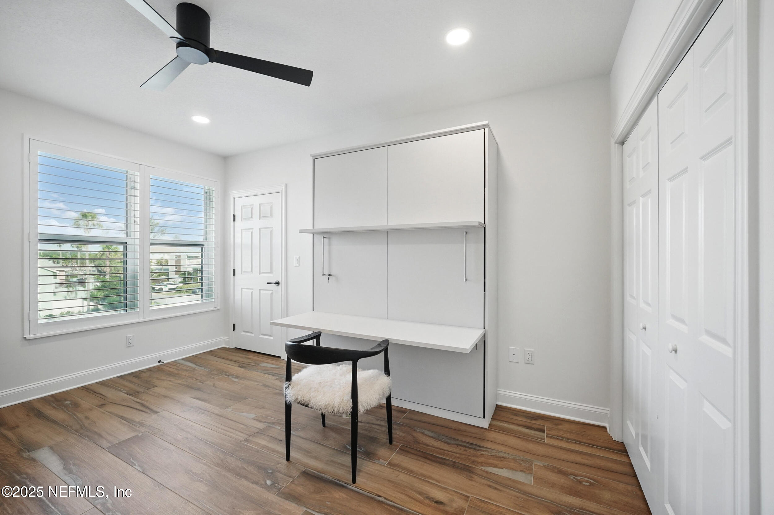 1505 1st Street South, Unit 302 Jacksonville Beach, FL 32250 - Photo 39 of 57 a view of an empty room with a window and wooden floor