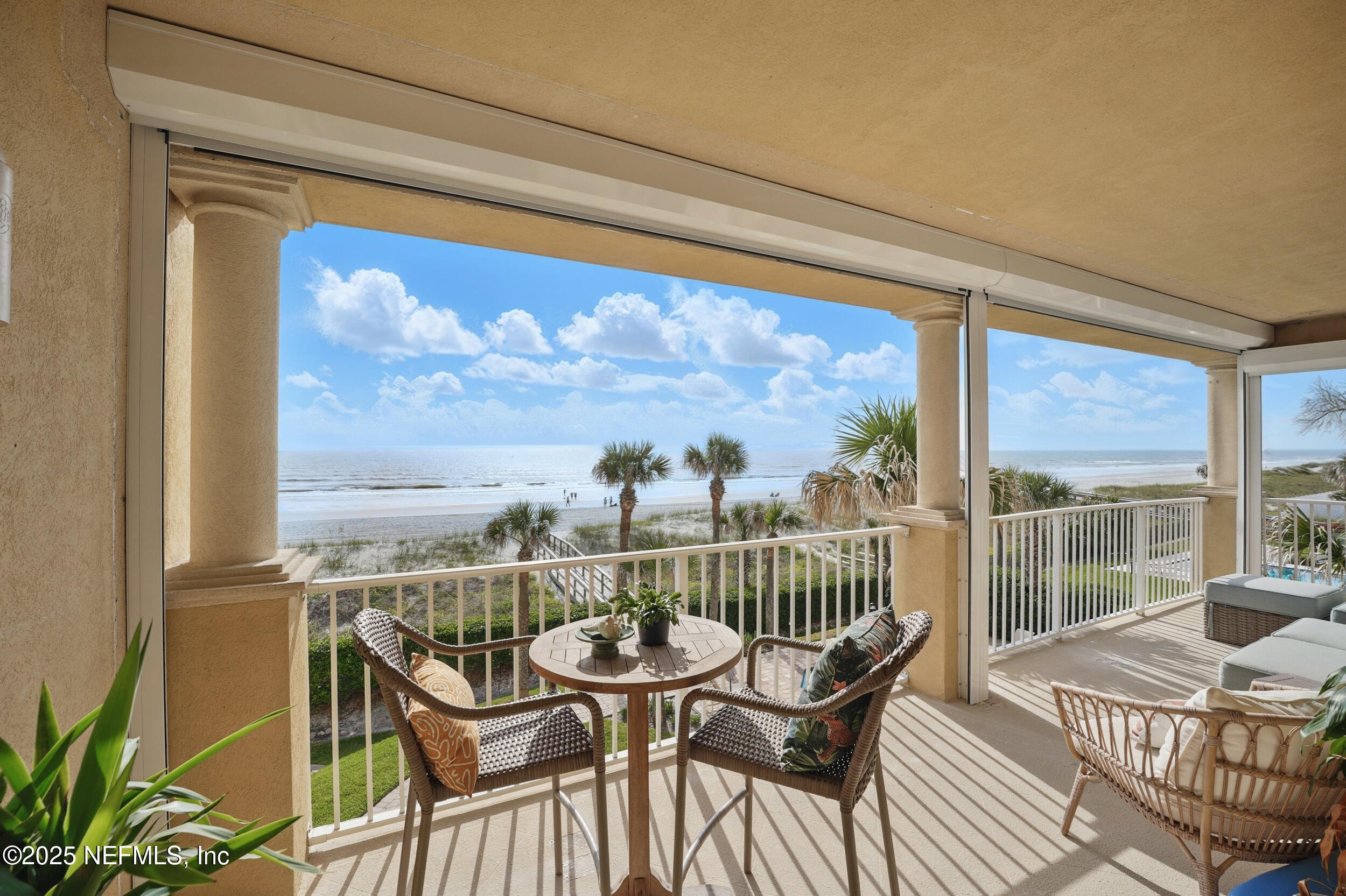 1505 1st Street South, Unit 302 Jacksonville Beach, FL 32250 - Photo 44 of 57 a view of a chair and table on the balcony