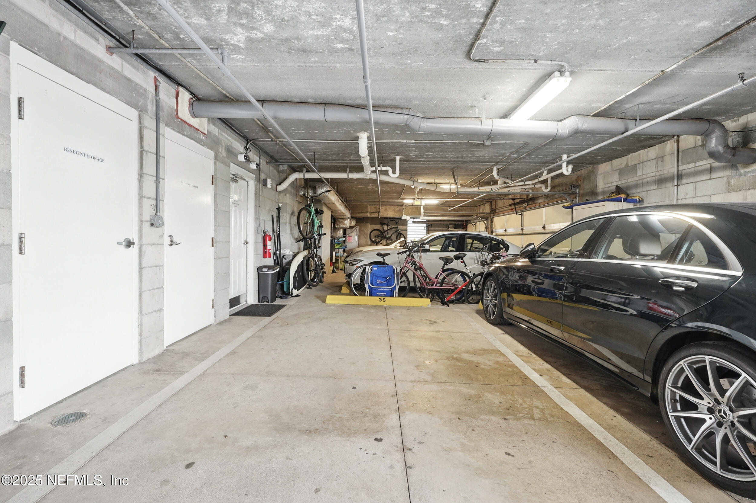 1505 1st Street South, Unit 302 Jacksonville Beach, FL 32250 - Photo 46 of 57 a view of parking garage with cars parked