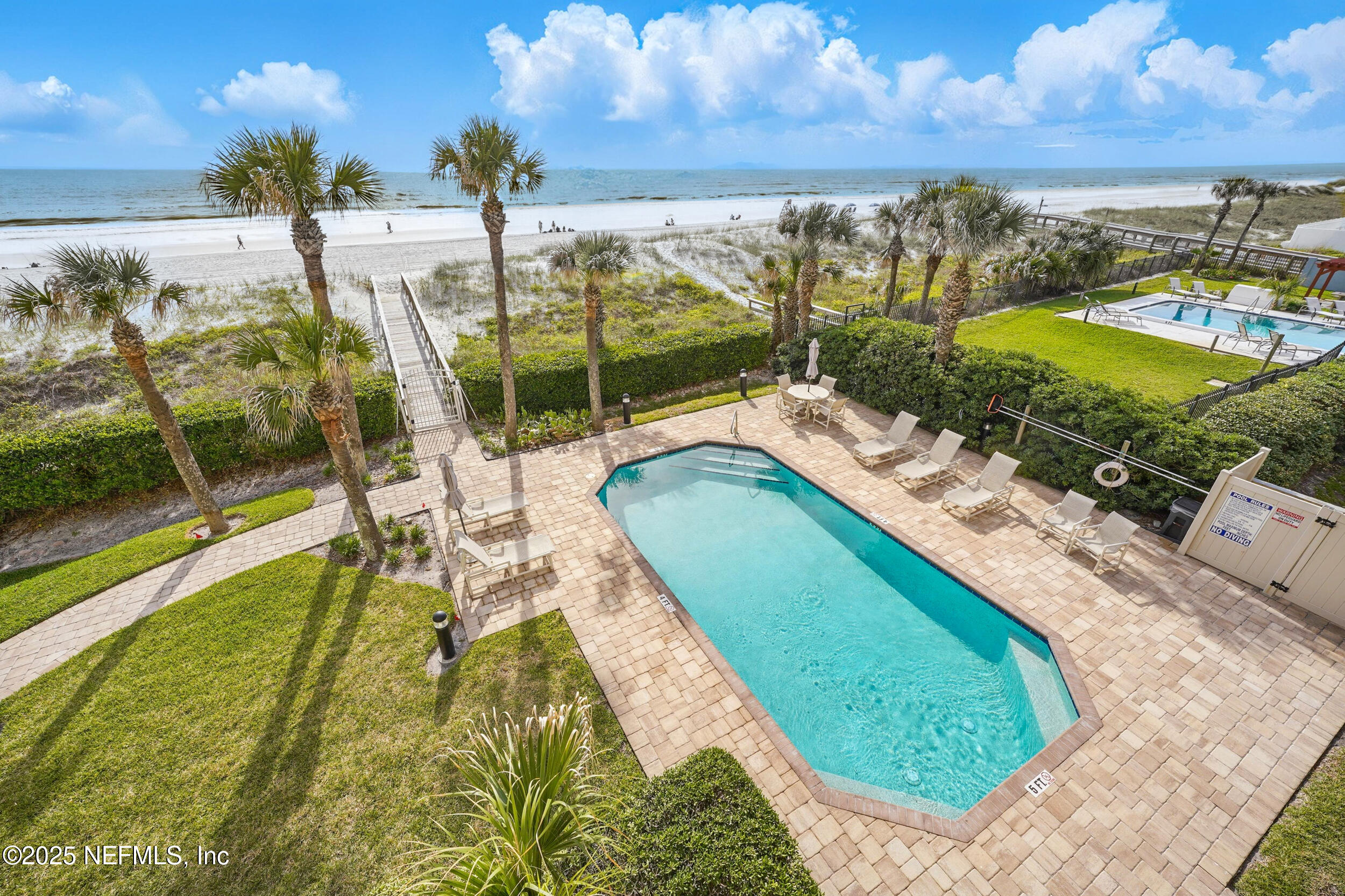 1505 1st Street South, Unit 302 Jacksonville Beach, FL 32250 - Photo 49 of 57 a view of a swimming pool with a garden