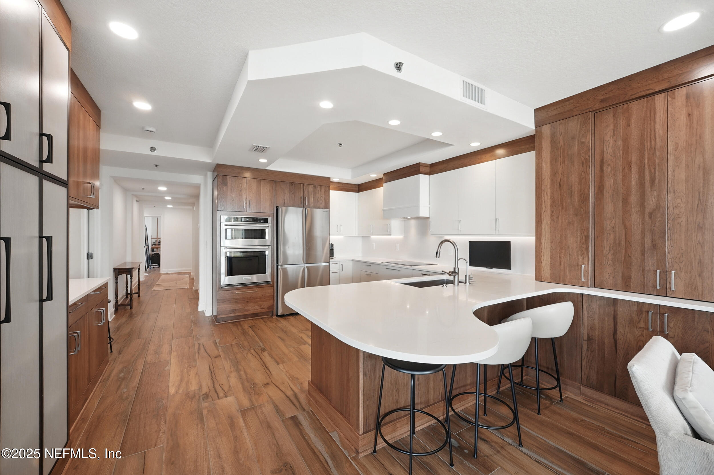 1505 1st Street South, Unit 302 Jacksonville Beach, FL 32250 - Photo 8 of 57 a large kitchen with a table and chairs in it