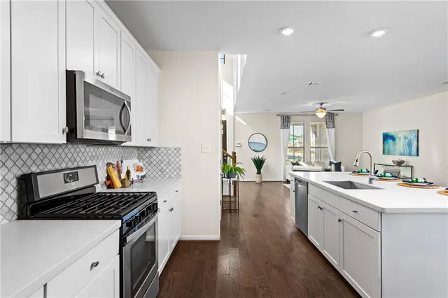 a kitchen with a sink stove and microwave