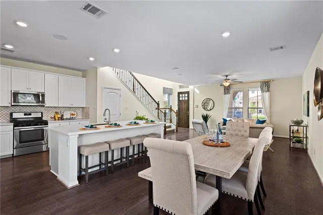 a large kitchen with a table and chairs