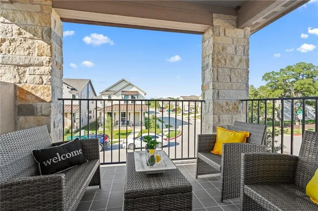 a balcony with furniture and wooden floor
