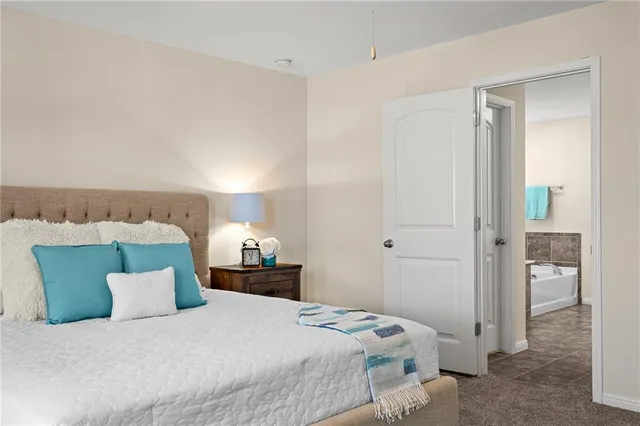 a bedroom with a bed and a night stand