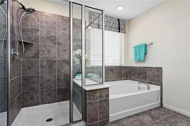 a bathroom with a bathtub and a shower