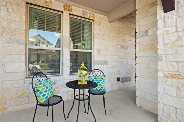 a backyard of a house with table and chairs