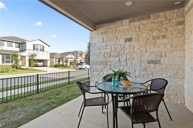 a view of a patio with table and chairs