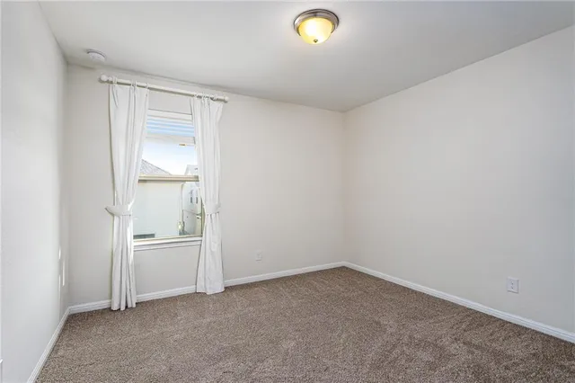 an empty room with cabinet and mirrors