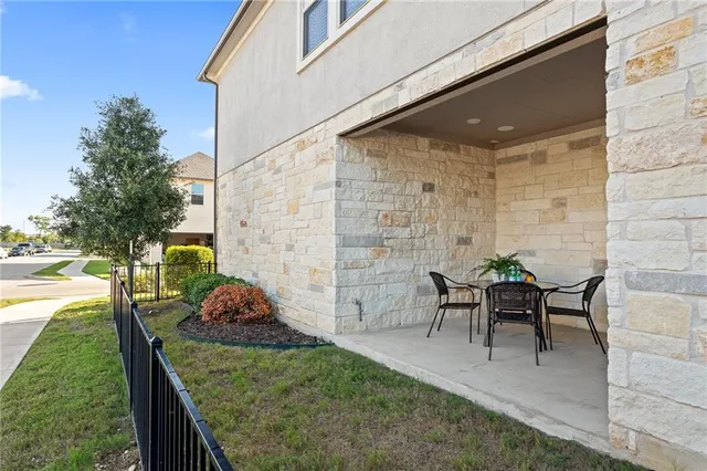 a view of a patio with table and chairs potted plants with wooden fence