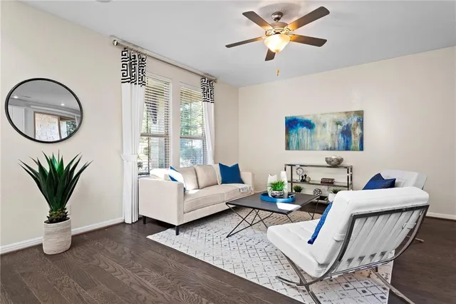a living room with furniture a potted plant and a chandelier