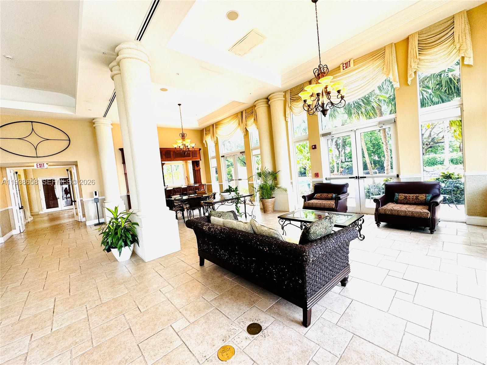 17150 North Bay Road, Unit 2412 Sunny Isles Beach, FL 33160 - Photo 19 of 25 a living room with fireplace furniture and a large window