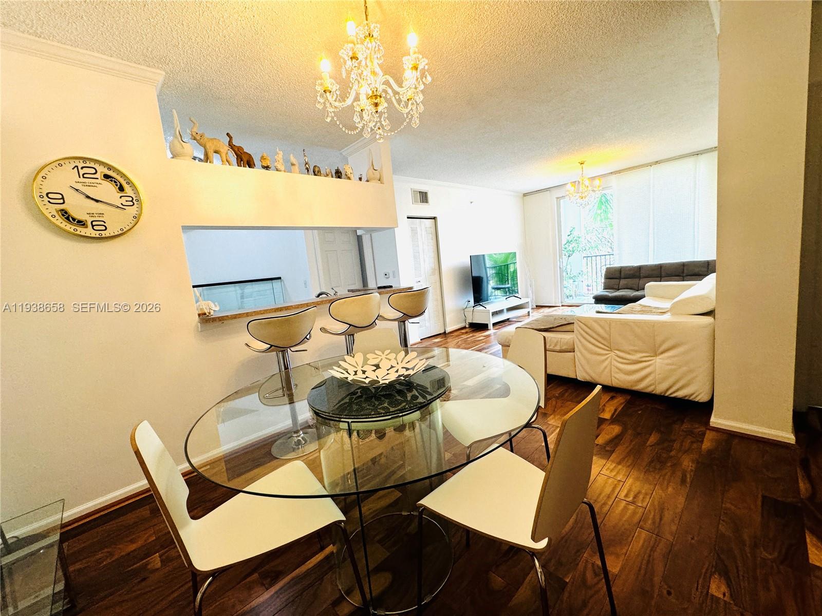 17150 North Bay Road, Unit 2412 Sunny Isles Beach, FL 33160 - Photo 2 of 25 a living room with furniture and a chandelier