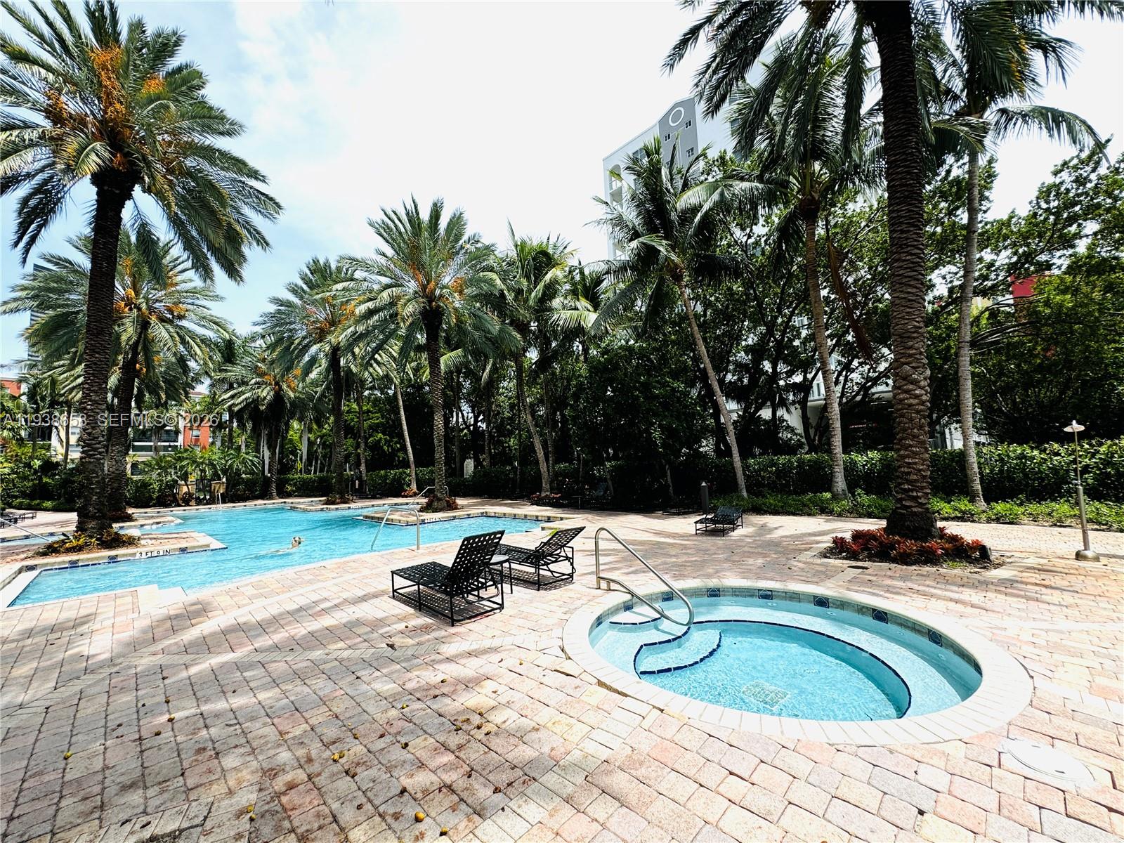 17150 North Bay Road, Unit 2412 Sunny Isles Beach, FL 33160 - Photo 21 of 29 a swimming pool with outdoor seating and yard