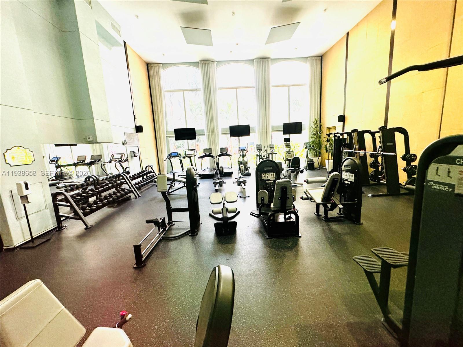 17150 North Bay Road, Unit 2412 Sunny Isles Beach, FL 33160 - Photo 23 of 25 a living room with lots of chairs and a table