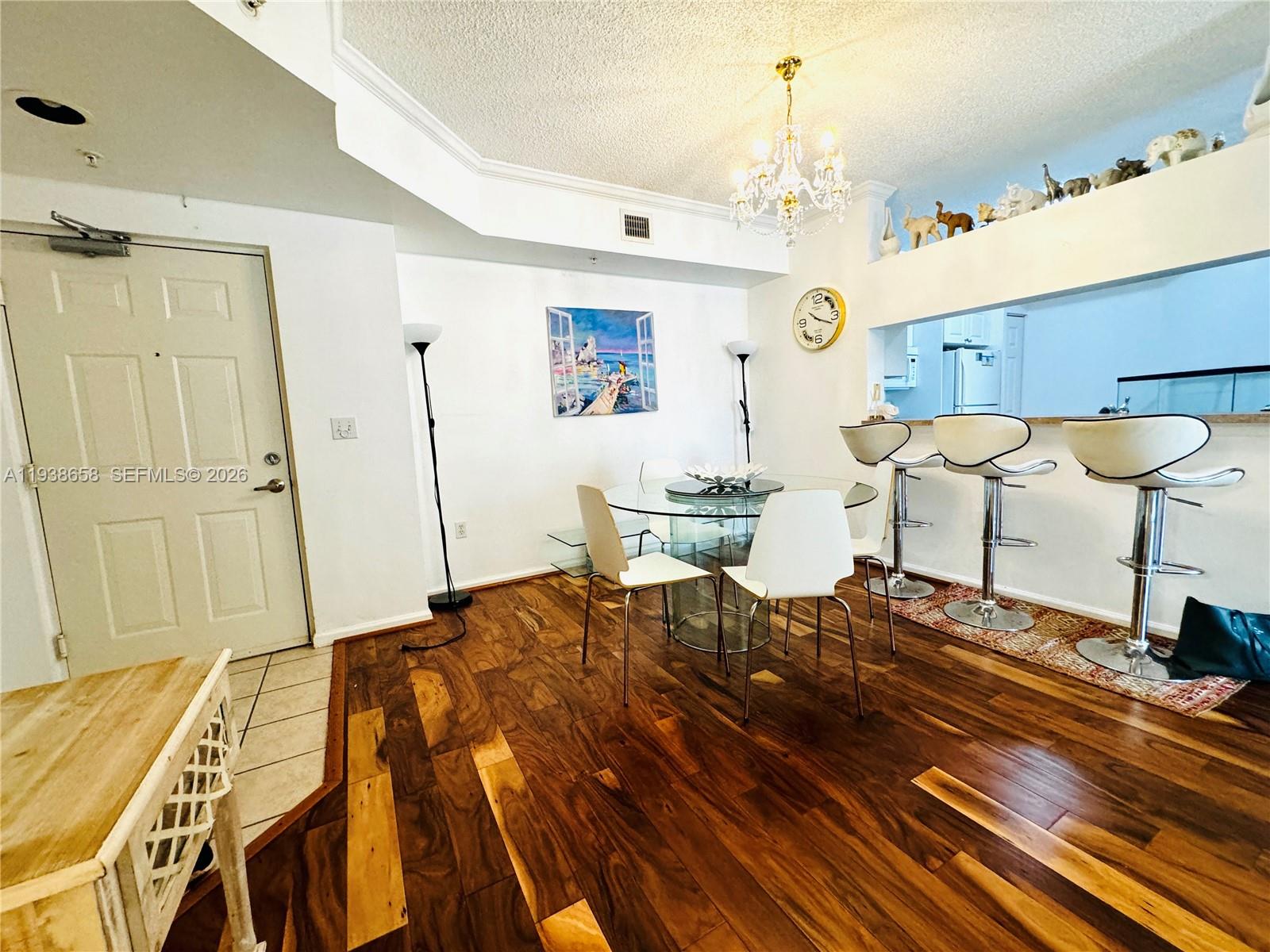 17150 North Bay Road, Unit 2412 Sunny Isles Beach, FL 33160 - Photo 3 of 25 a bedroom with a bed and a chandelier