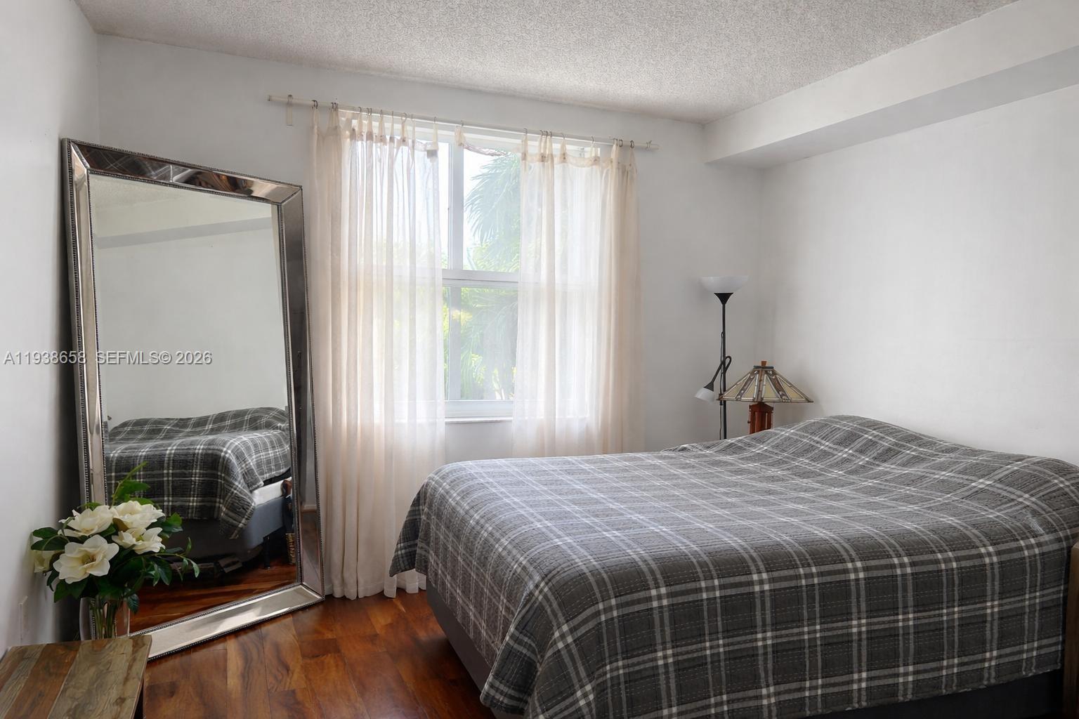 17150 North Bay Road, Unit 2412 Sunny Isles Beach, FL 33160 - Photo 4 of 25 a bedroom with a bed and a window