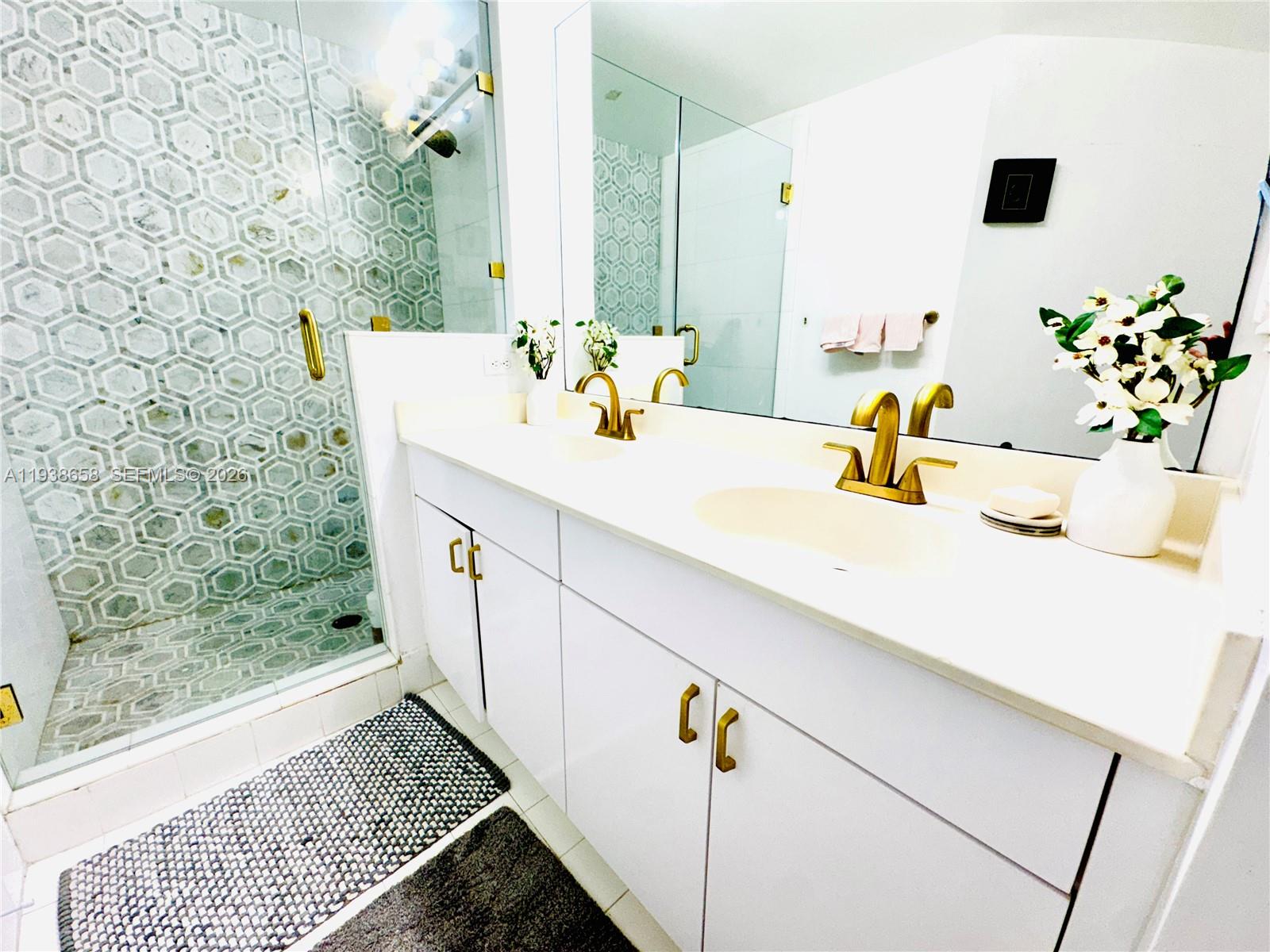 17150 North Bay Road, Unit 2412 Sunny Isles Beach, FL 33160 - Photo 6 of 25 a bathroom with a sink and a mirror