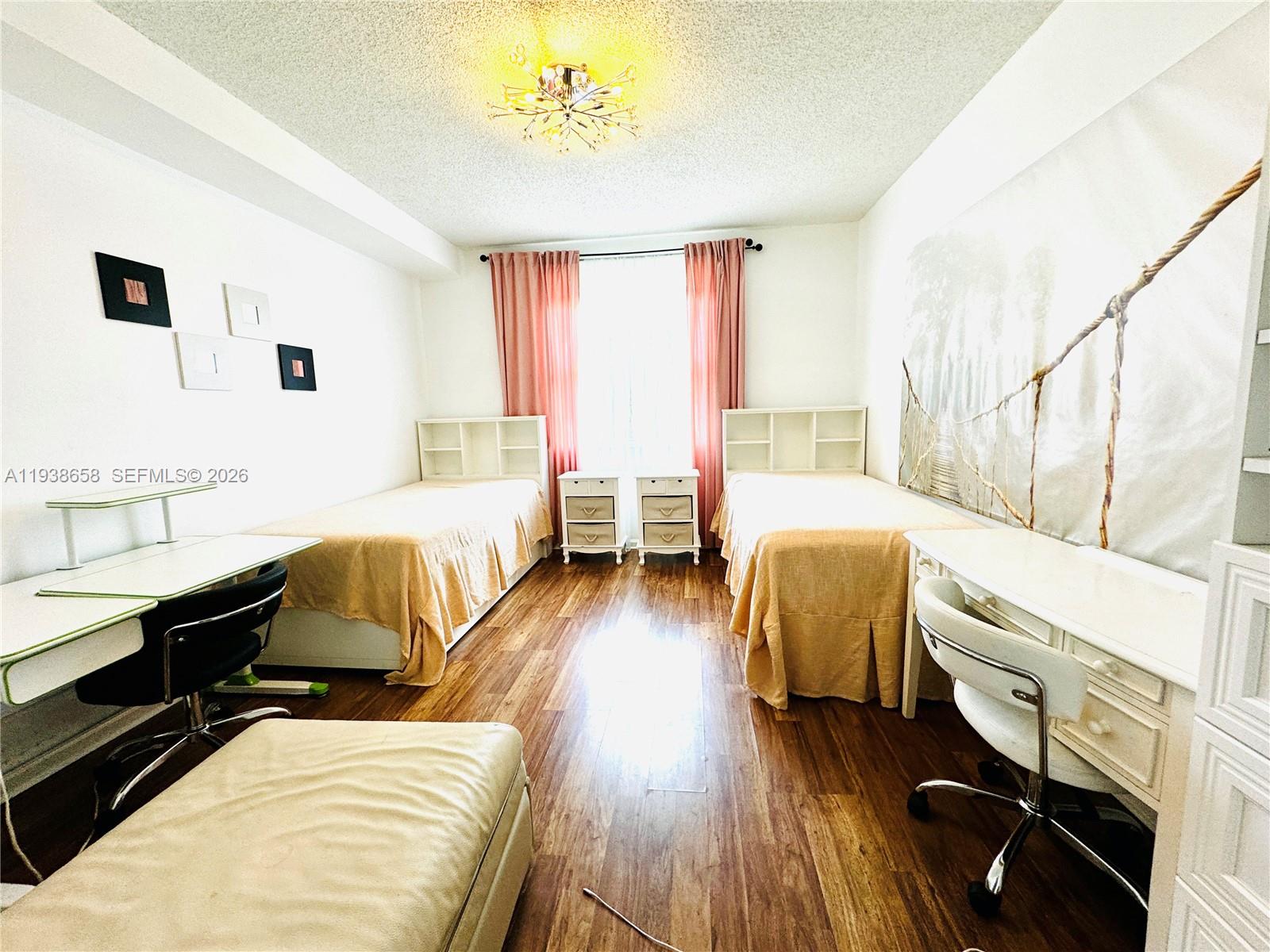 17150 North Bay Road, Unit 2412 Sunny Isles Beach, FL 33160 - Photo 7 of 29 a bedroom with furniture and a wooden floor