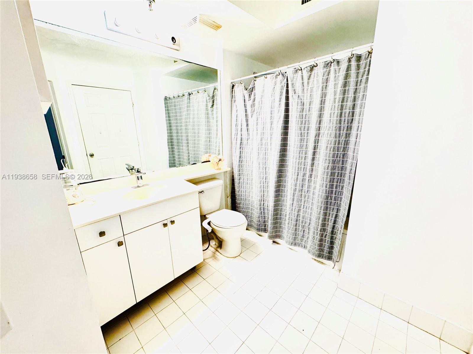 17150 North Bay Road, Unit 2412 Sunny Isles Beach, FL 33160 - Photo 9 of 25 a spacious bathroom with a double vanity sink a mirror and a shower