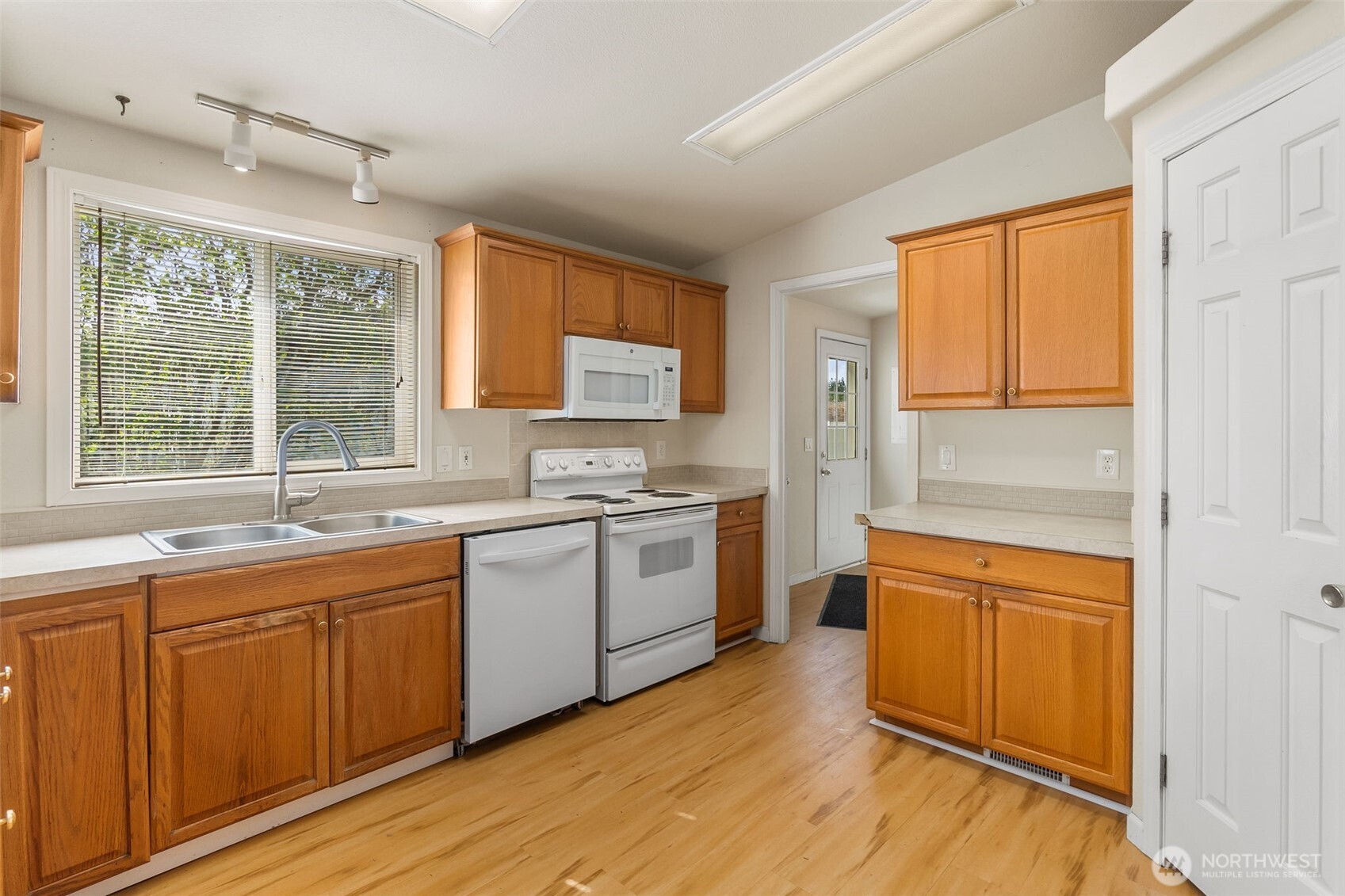 271 Romerman Road, Unit 22 Chehalis, WA 98532 - Photo 5 of 27 a kitchen with a window wooden floor and stainless steel appliances