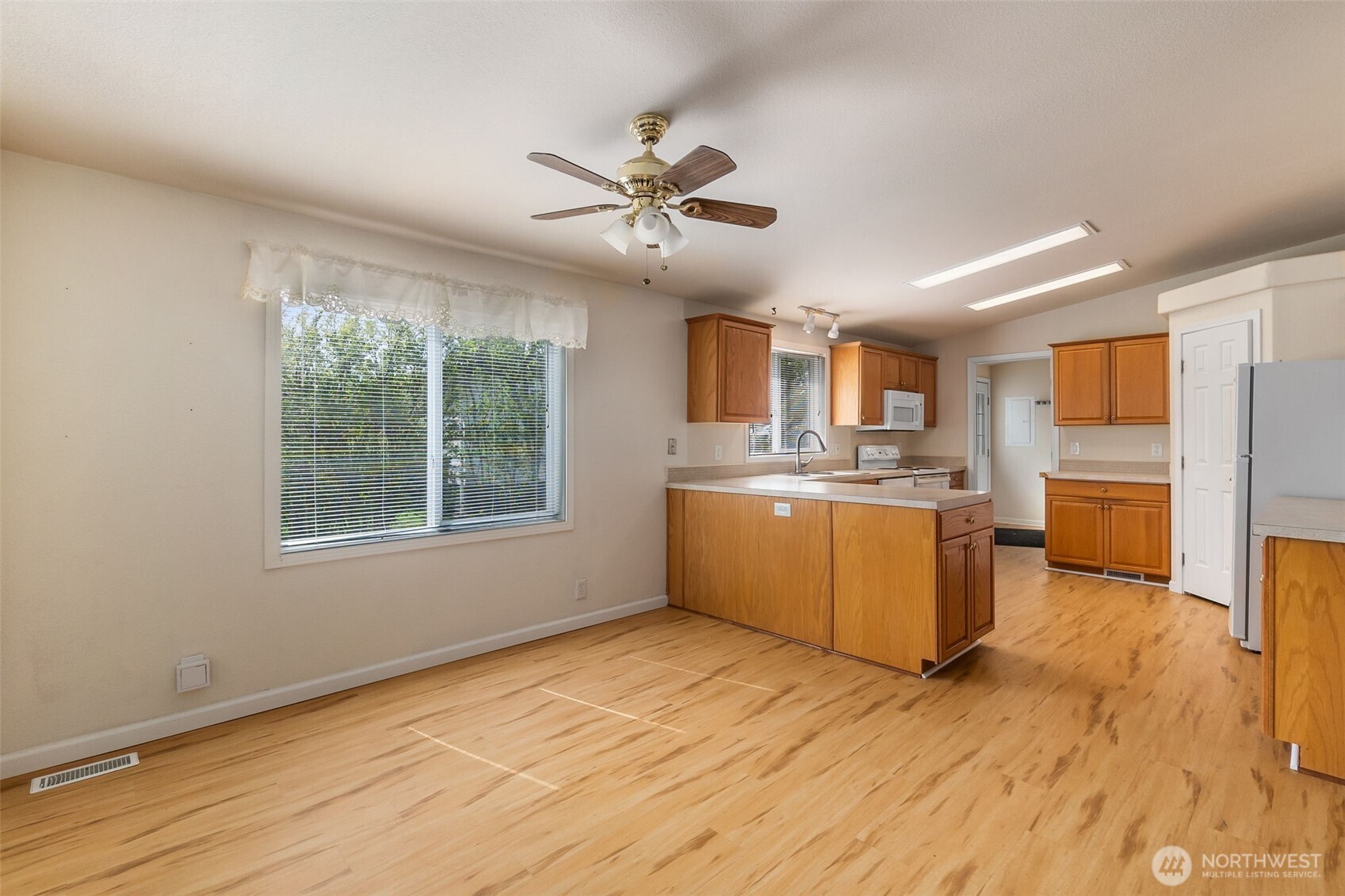 271 Romerman Road, Unit 22 Chehalis, WA 98532 - Photo 7 of 27 a view of a kitchen with wooden floor and a window