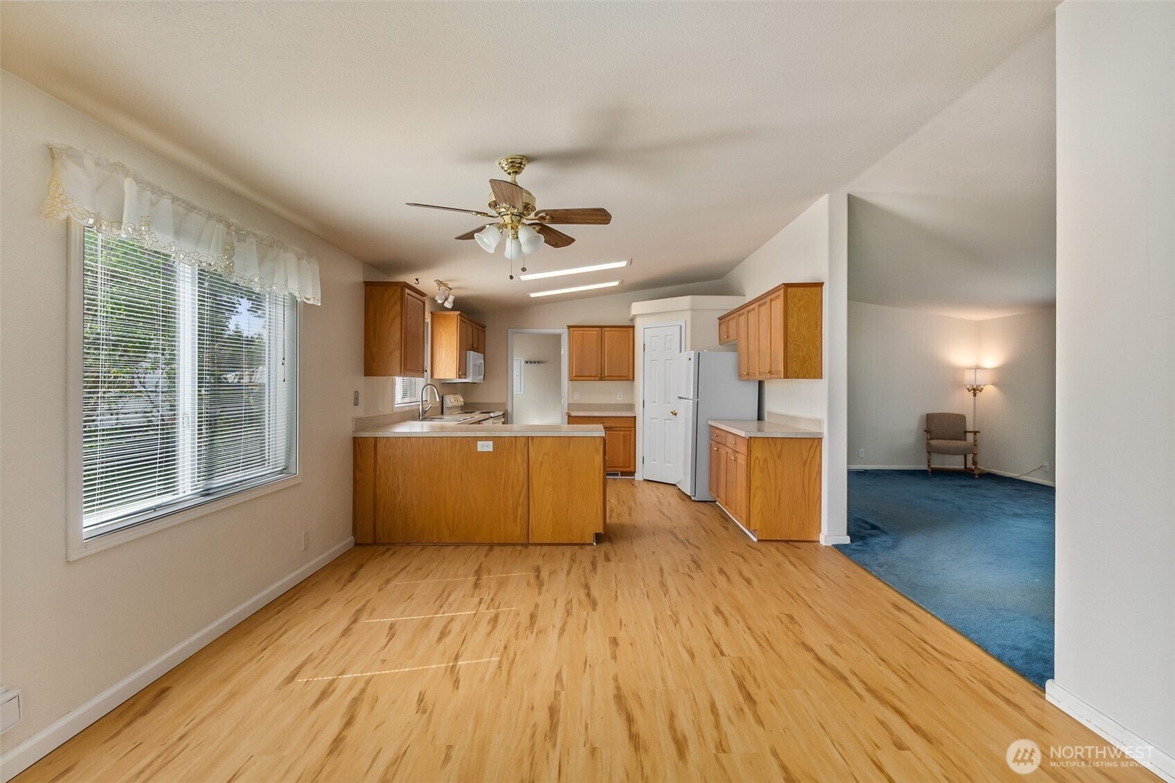 271 Romerman Road, Unit 22 Chehalis, WA 98532 - Photo 8 of 27 a view of a kitchen with wooden floor and a window