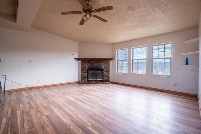 wooden floor fireplace and natural light in room