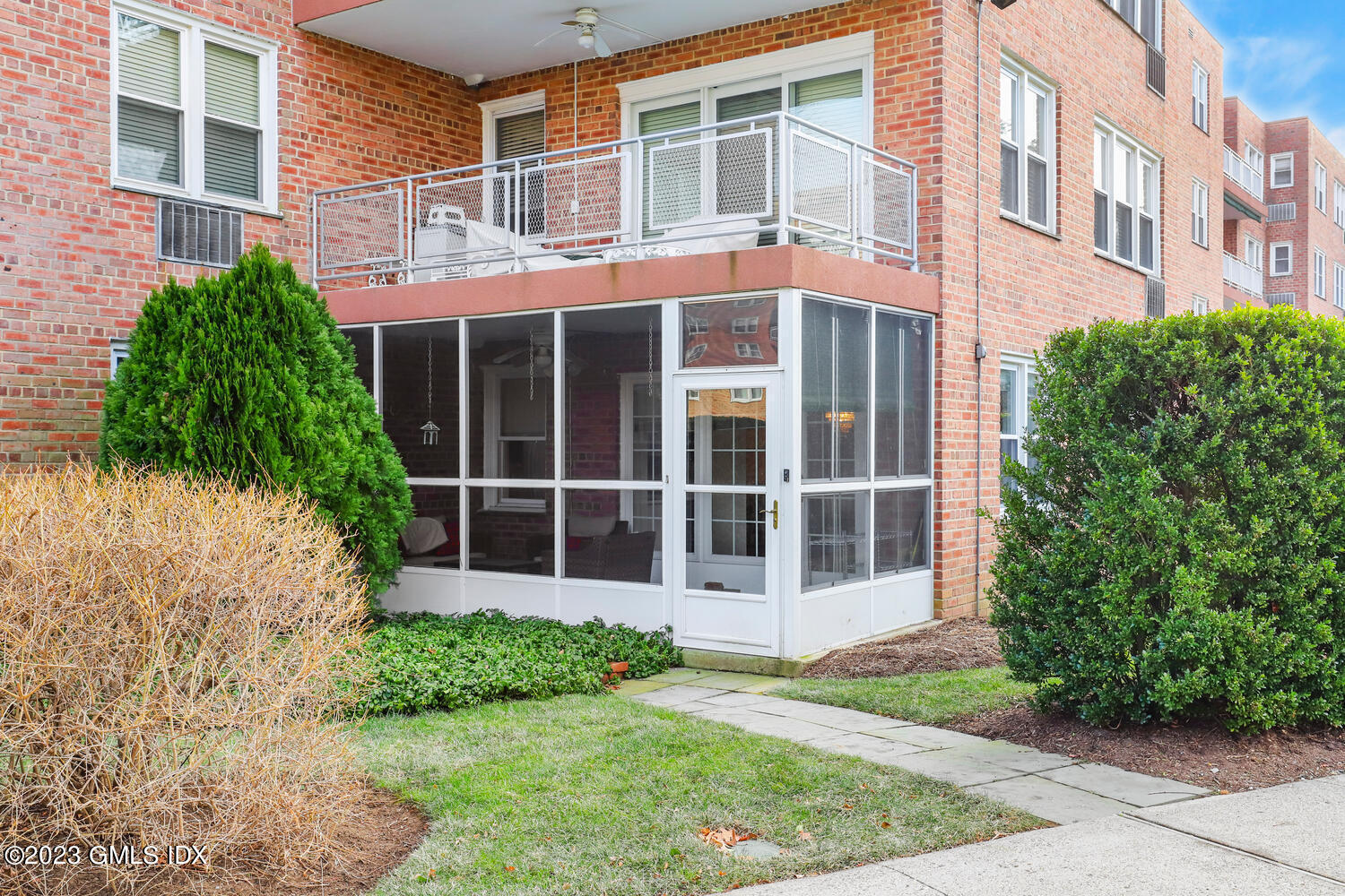 2 Putnam Hill, Unit 1C Greenwich, CT 06830 - Photo 11 of 13 front view of a brick building with a yard