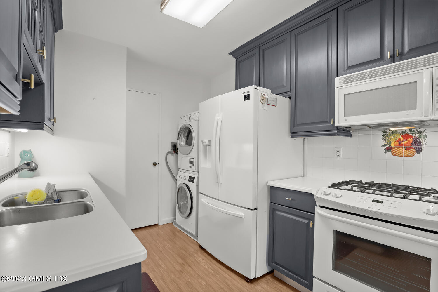 2 Putnam Hill, Unit 1C Greenwich, CT 06830 - Photo 6 of 13 a white refrigerator freezer and a stove sitting inside of a kitchen