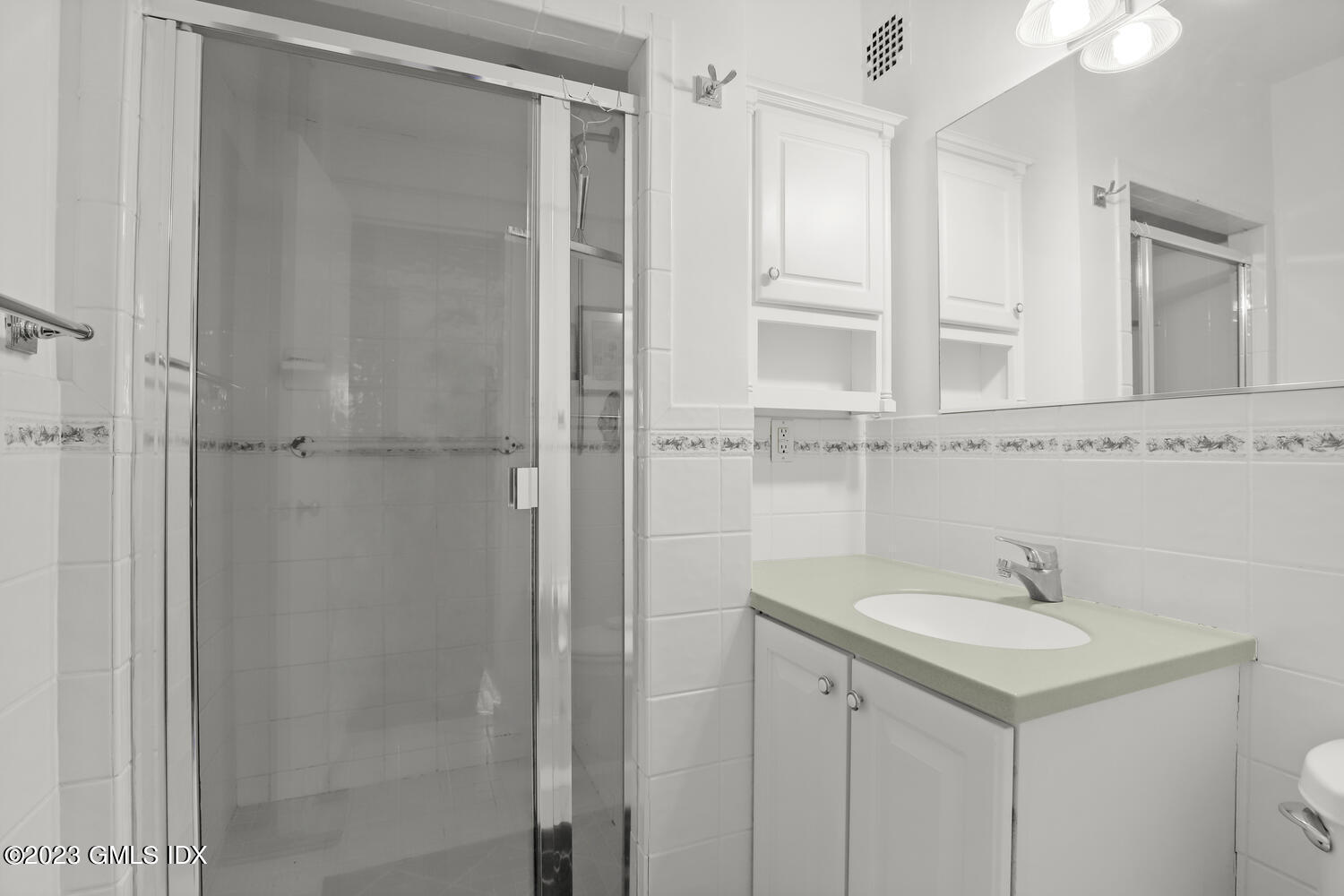 2 Putnam Hill, Unit 1C Greenwich, CT 06830 - Photo 9 of 13 a bathroom with a shower sink and mirror