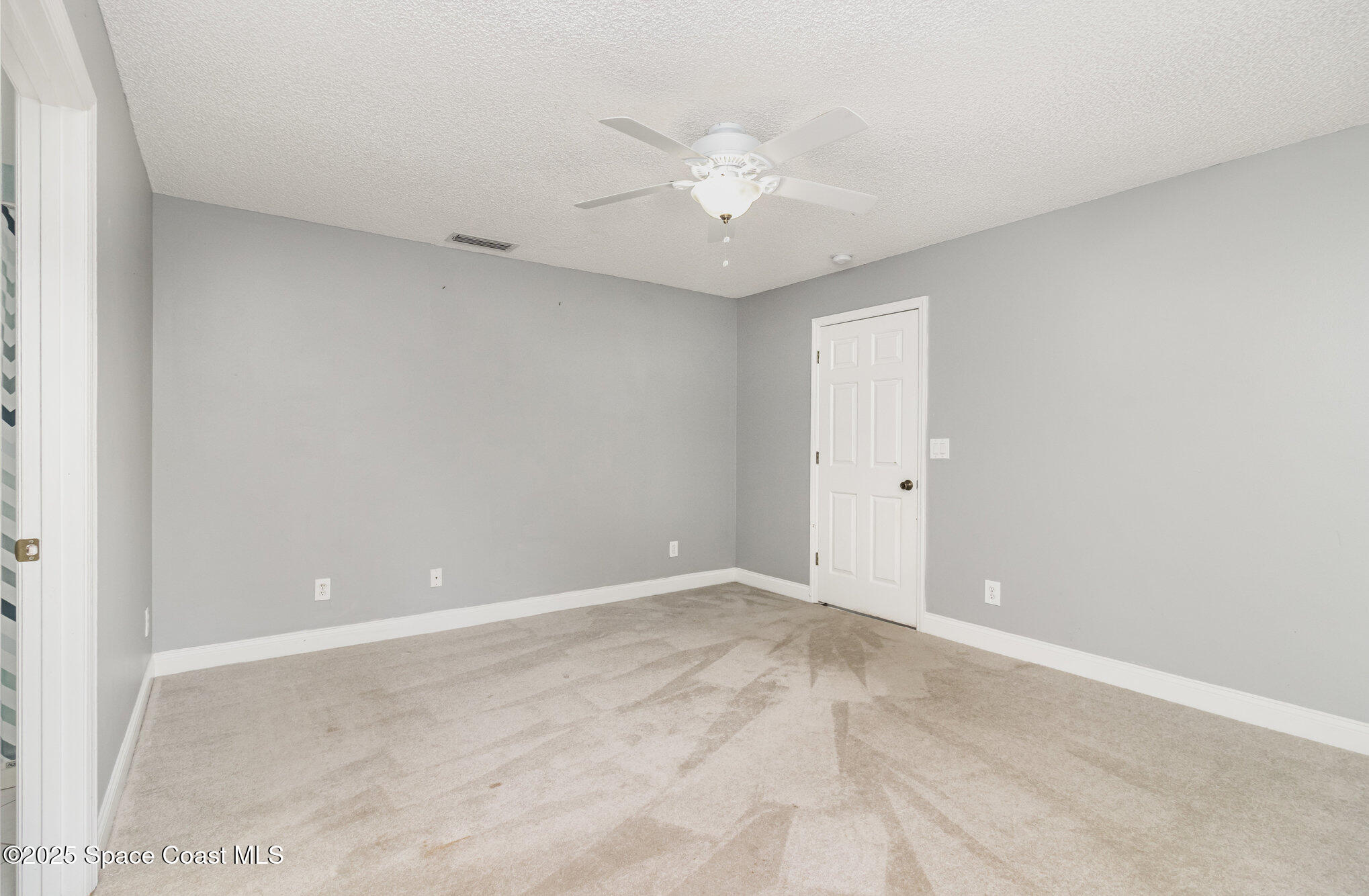561 Carnival Terrace Sebastian, FL 32958 - Photo 11 of 28 a view of an empty room with a fan