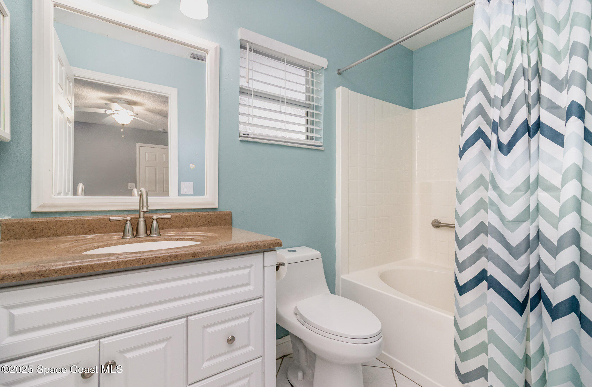 561 Carnival Terrace Sebastian, FL 32958 - Photo 13 of 28 a bathroom with a granite countertop sink and a mirror