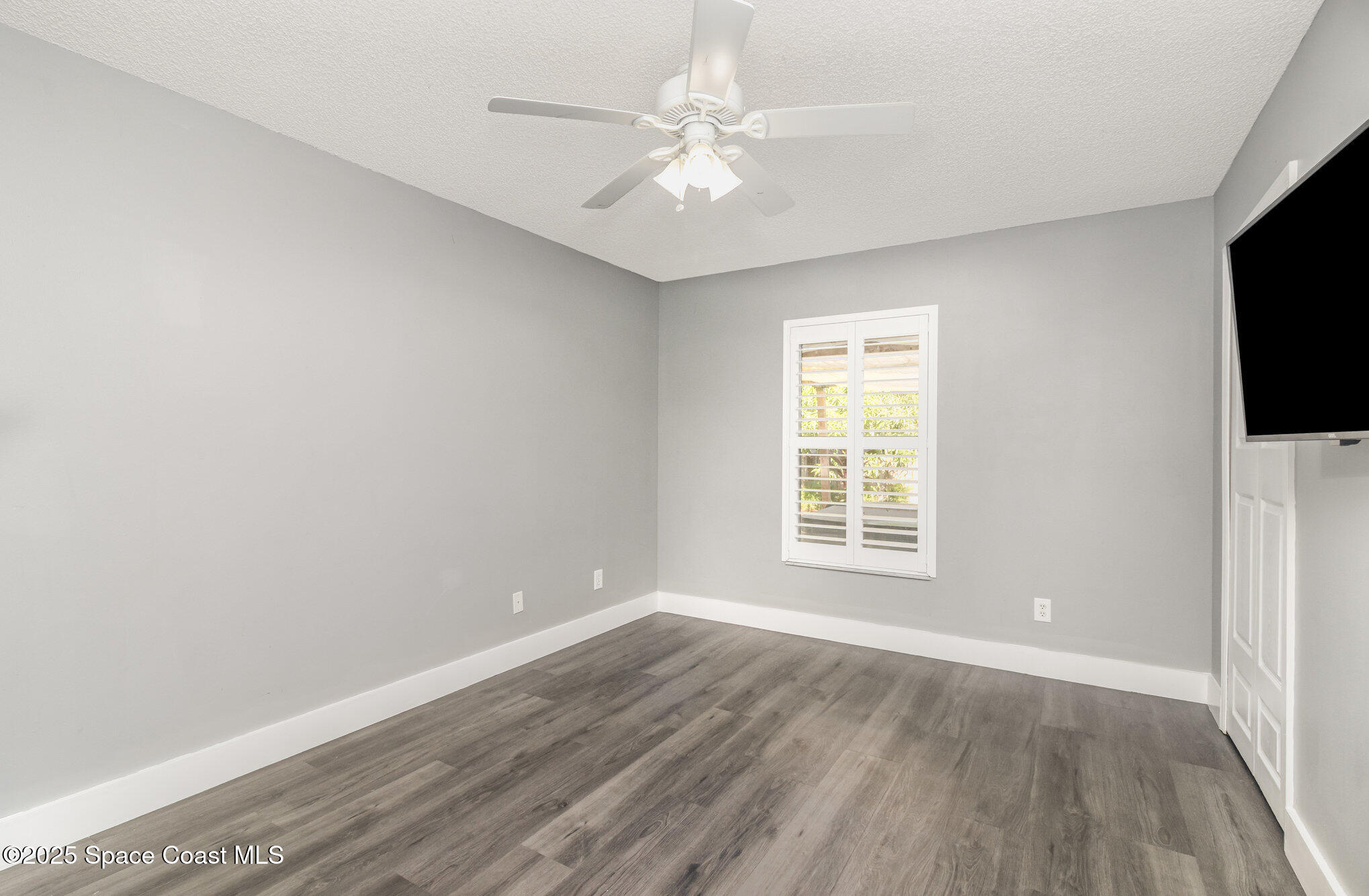 561 Carnival Terrace Sebastian, FL 32958 - Photo 14 of 28 wooden floor in an empty room with a window