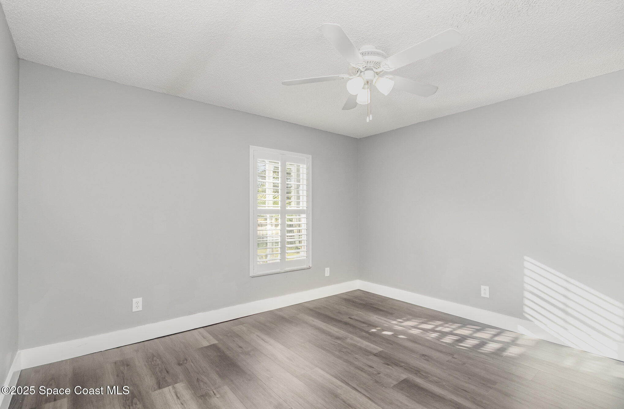 561 Carnival Terrace Sebastian, FL 32958 - Photo 15 of 28 wooden floor in an empty room with a window