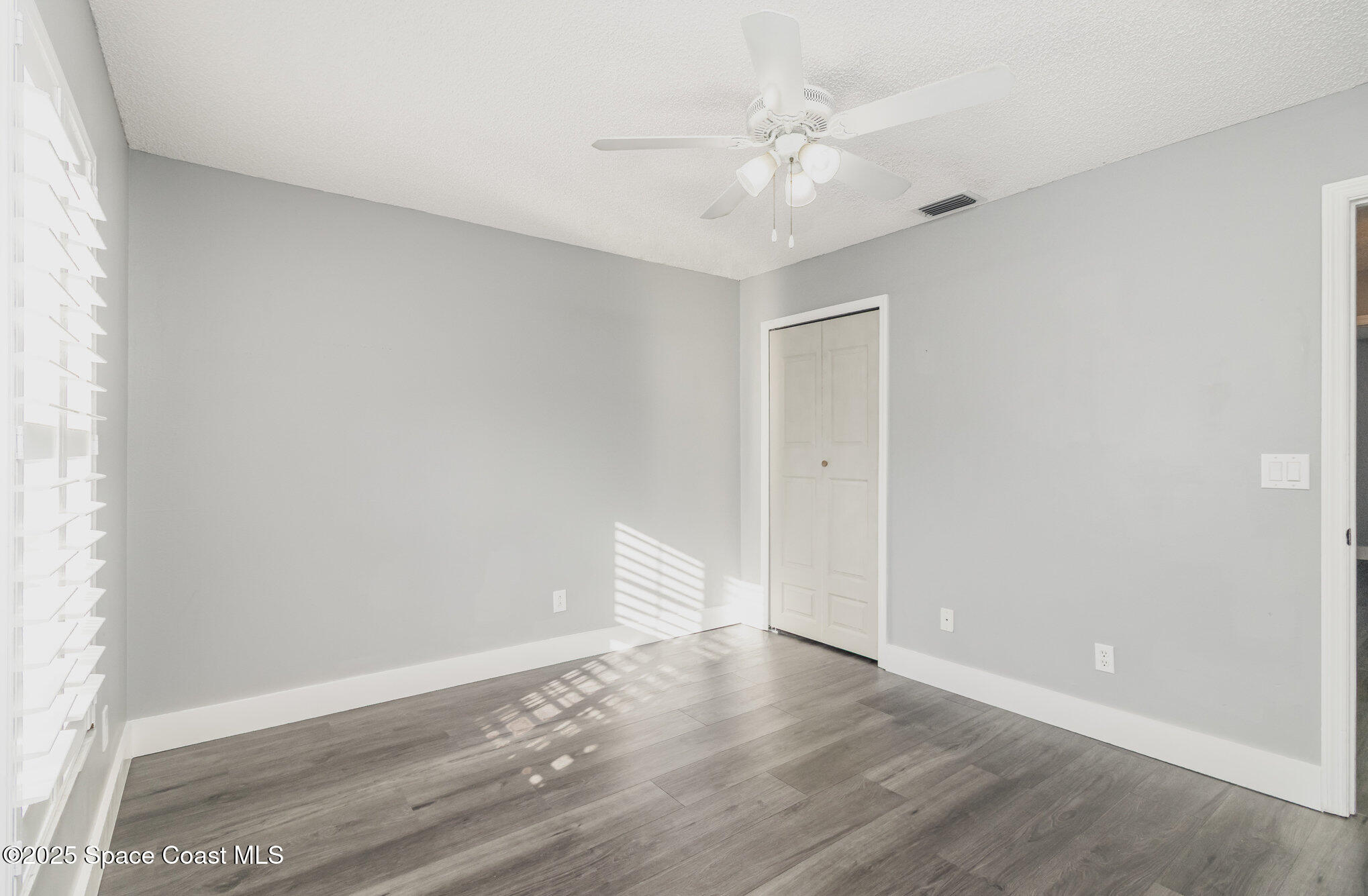 561 Carnival Terrace Sebastian, FL 32958 - Photo 18 of 28 wooden floor in an empty room