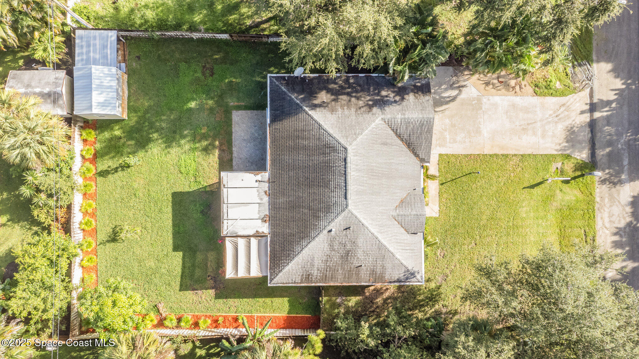 561 Carnival Terrace Sebastian, FL 32958 - Photo 27 of 28 a aerial view of a house with a yard and large trees