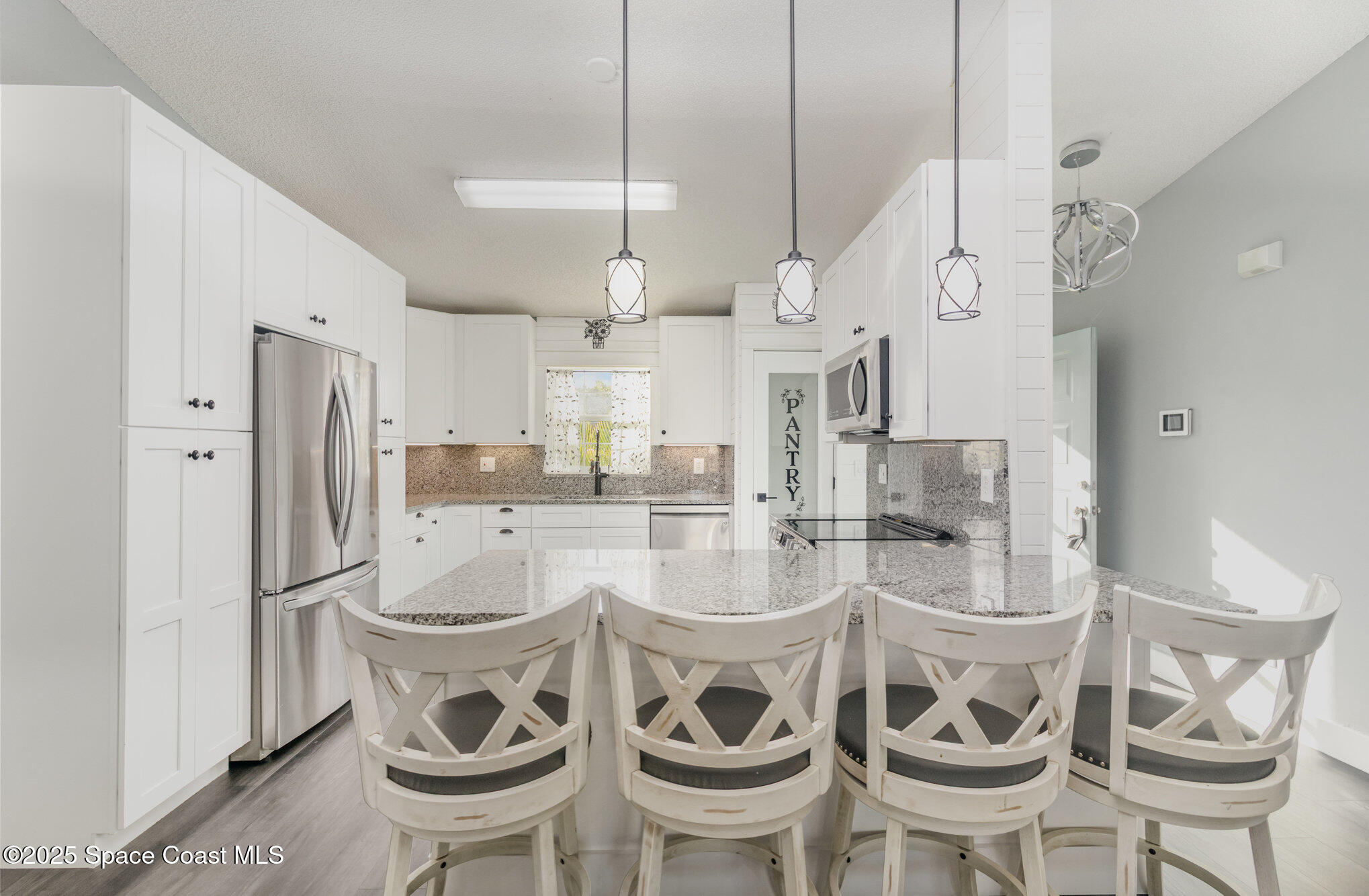 561 Carnival Terrace Sebastian, FL 32958 - Photo 2 of 28 a dining room with stainless steel appliances kitchen island a table and chairs