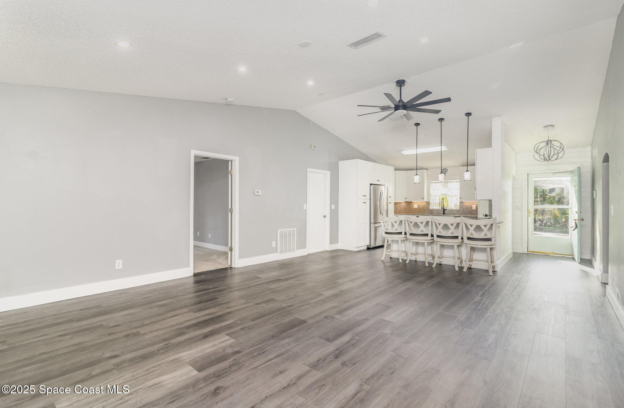 561 Carnival Terrace Sebastian, FL 32958 - Photo 3 of 28 a view of an empty room with a window and wooden floor