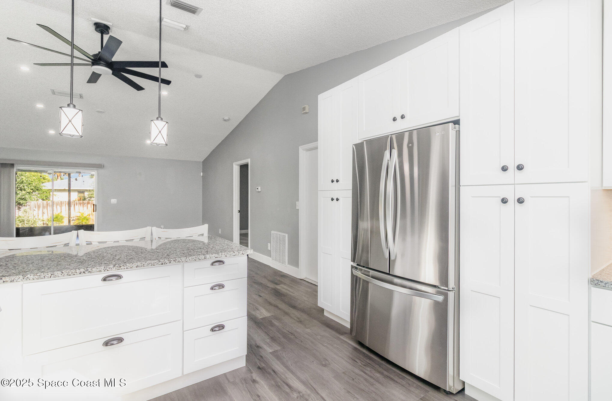 561 Carnival Terrace Sebastian, FL 32958 - Photo 5 of 28 a kitchen with kitchen island a counter top space wooden floor and appliances