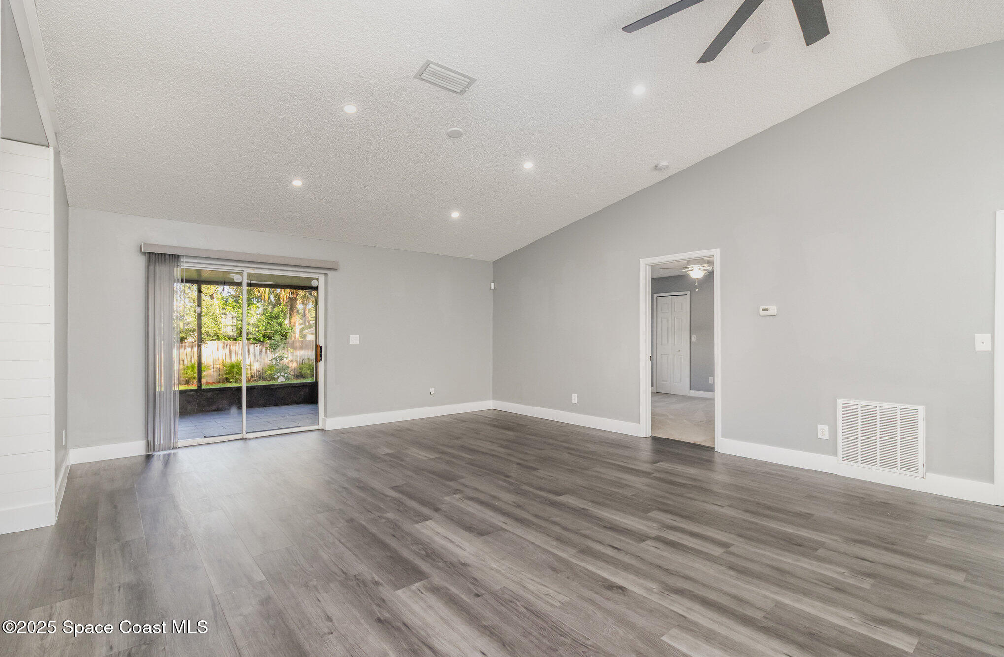 561 Carnival Terrace Sebastian, FL 32958 - Photo 8 of 28 a view of an empty room with wooden floor and a window