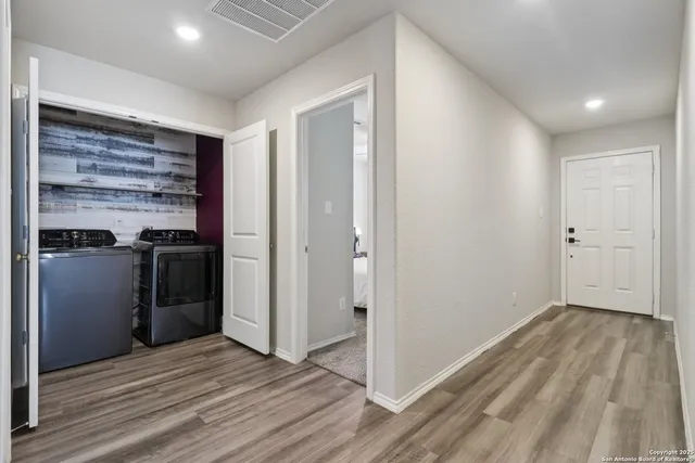 a view of a kitchen with a sink and a refrigerator