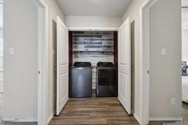 a view of a hallway with wooden floor and a hallway