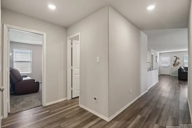 a view of living room with furniture and wooden floor