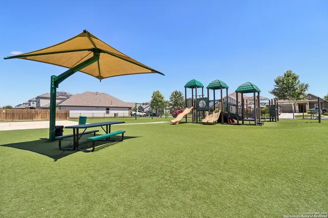 a view of a house with backyard and porch
