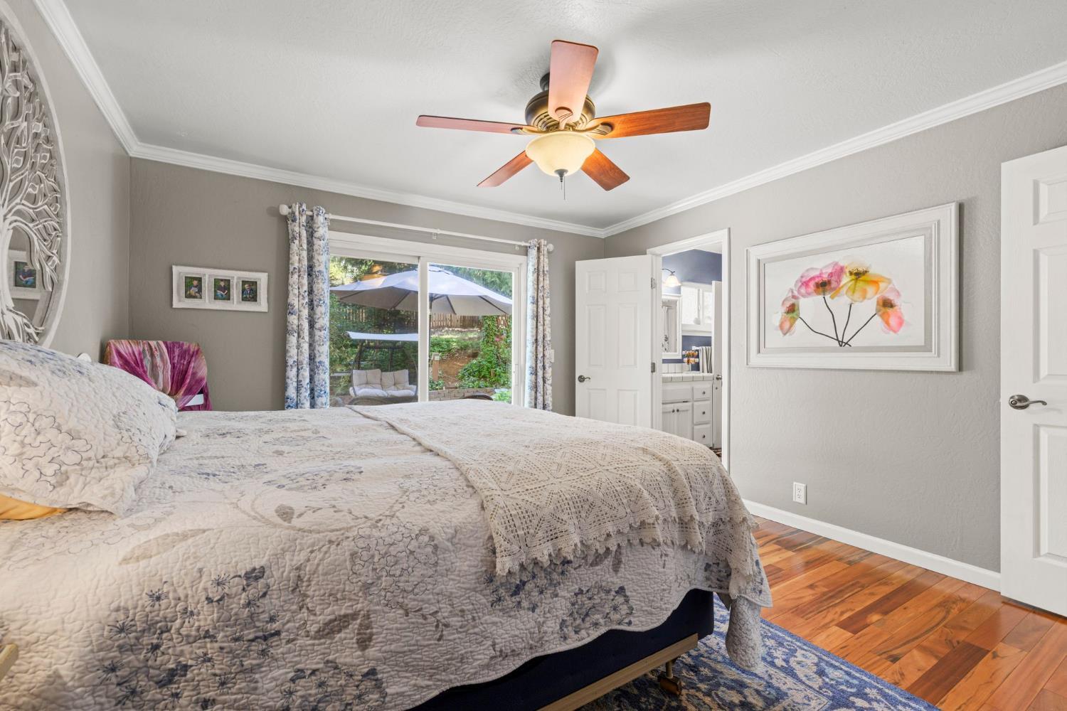 2812 Crystal Springs Road Camino, CA 95709 - Photo 17 of 28 a bedroom with a large bed and a chandelier